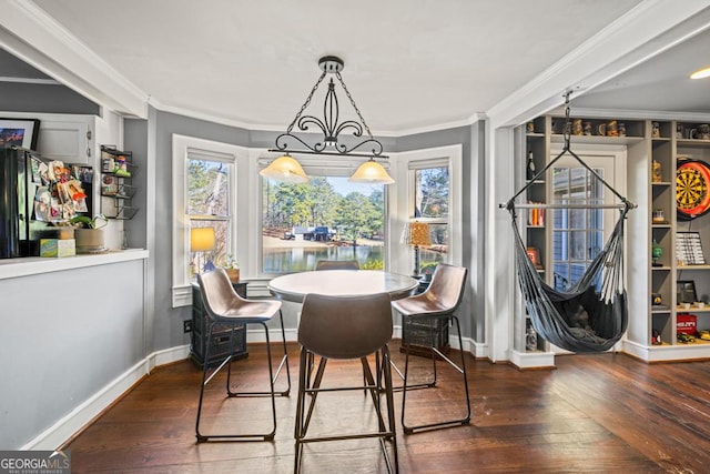 dining area with dark hardwood / wood-style flooring, a chandelier, and a wealth of natural light