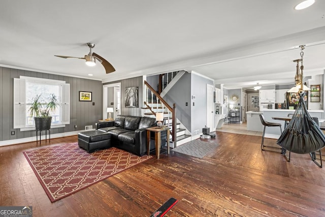 living room with crown molding, hardwood / wood-style floors, and ceiling fan