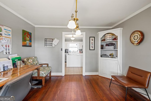 interior space with dark wood-type flooring, ornamental molding, and sink