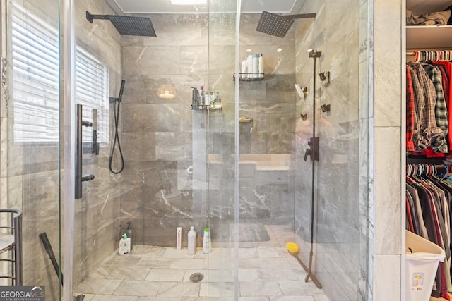 bathroom with a shower with door