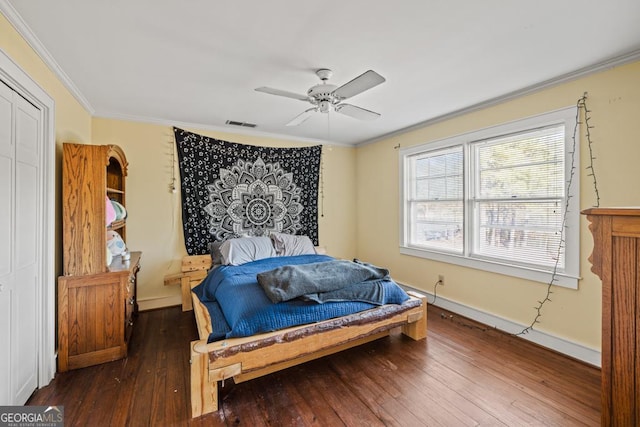 bedroom with crown molding, ceiling fan, and dark hardwood / wood-style flooring