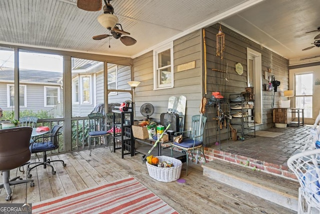 sunroom / solarium featuring ceiling fan