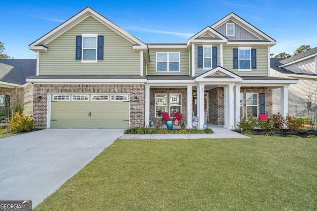 view of front of property featuring a front yard, a porch, and a garage