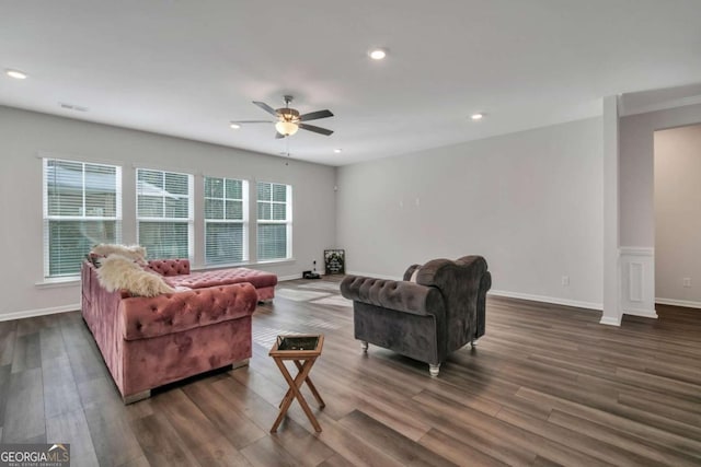 living room featuring dark hardwood / wood-style floors, ceiling fan, and plenty of natural light