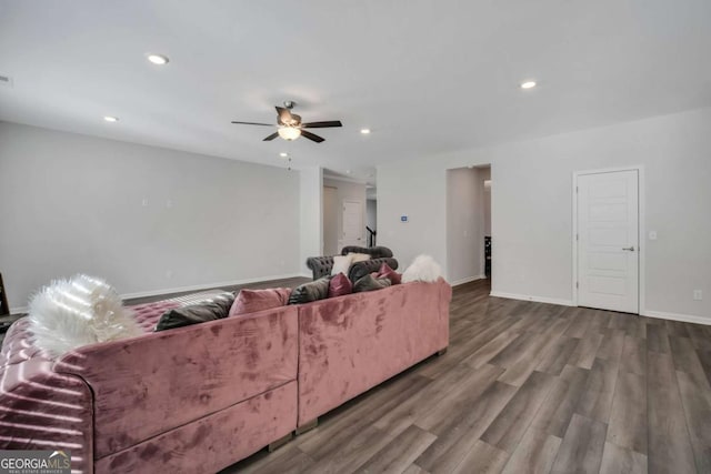 living room featuring ceiling fan and wood-type flooring