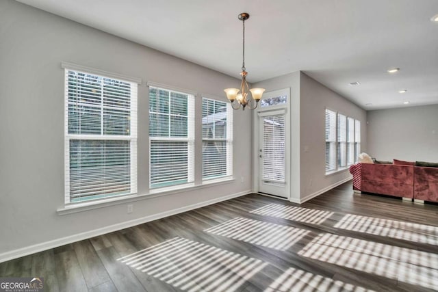 dining room with dark hardwood / wood-style flooring and a notable chandelier