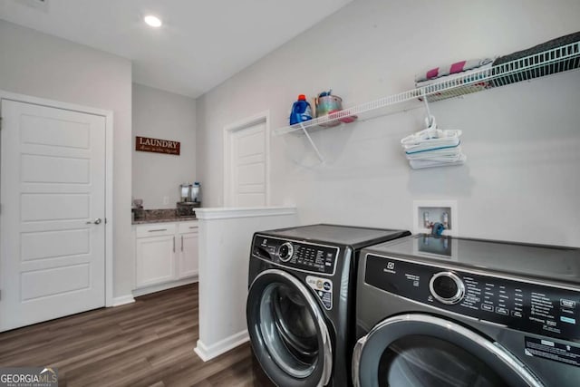 laundry area featuring dark wood-type flooring and washer and clothes dryer