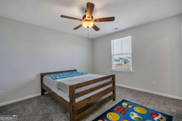 bedroom featuring ceiling fan and dark carpet