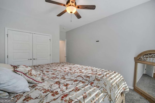 carpeted bedroom with ceiling fan and a closet