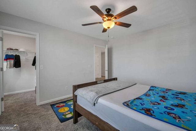 carpeted bedroom with ceiling fan and a closet