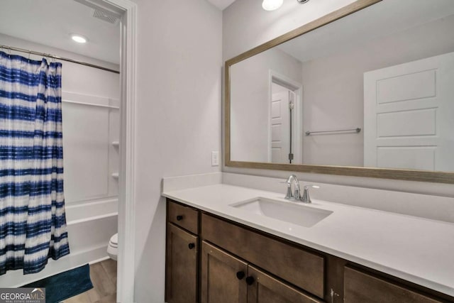 full bathroom with toilet, vanity, and shower / tub combo with curtain