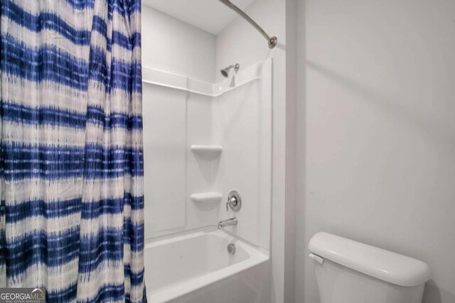 bathroom with toilet and shower / tub combo