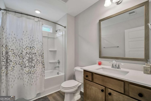 full bathroom with toilet, shower / tub combo, vanity, and hardwood / wood-style floors