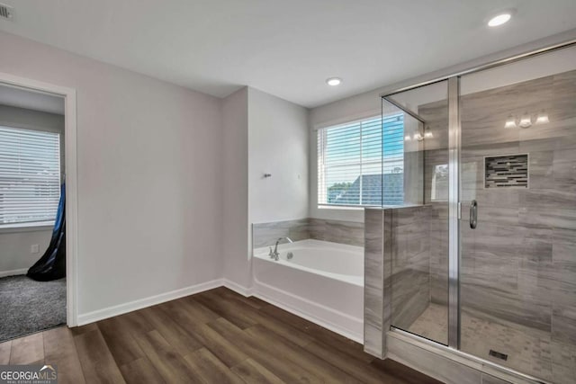 bathroom featuring separate shower and tub and hardwood / wood-style floors