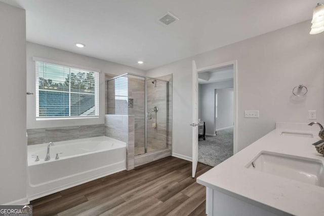 bathroom featuring separate shower and tub, wood-type flooring, and vanity