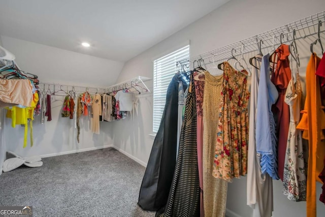 walk in closet featuring carpet flooring and lofted ceiling