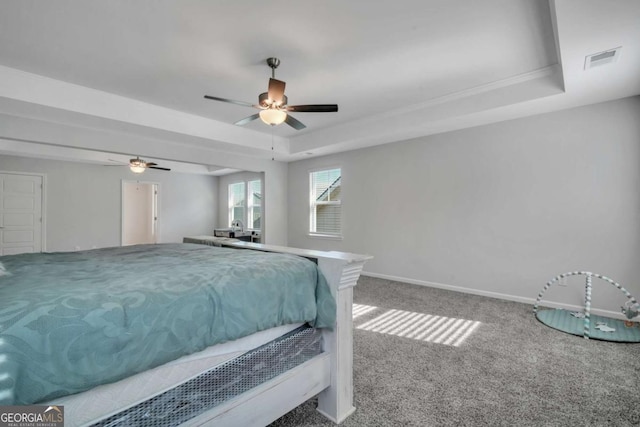 bedroom featuring a raised ceiling, ceiling fan, and carpet floors