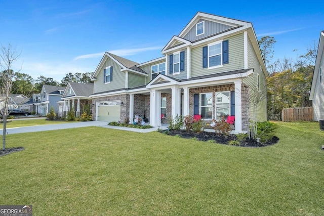 view of front of property featuring a front yard, a garage, and a porch