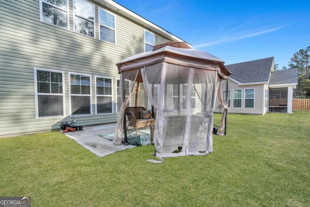 back of property with a gazebo and a yard