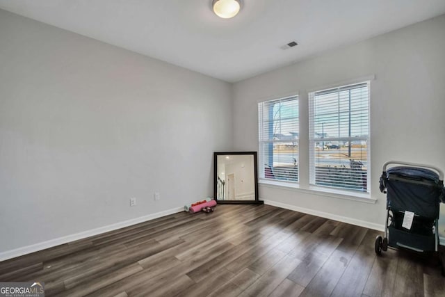 home office with dark wood-type flooring