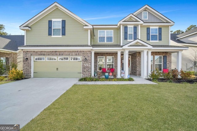 view of front of home featuring a garage, a front lawn, and a porch