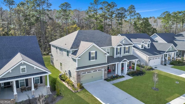 view of front of house with a front lawn, a porch, and a garage