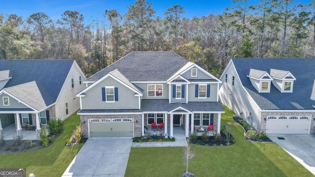 view of front of home with covered porch, a front lawn, and a garage