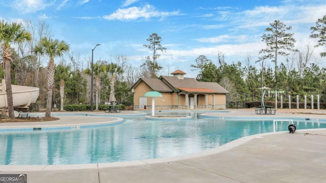 view of swimming pool featuring a patio