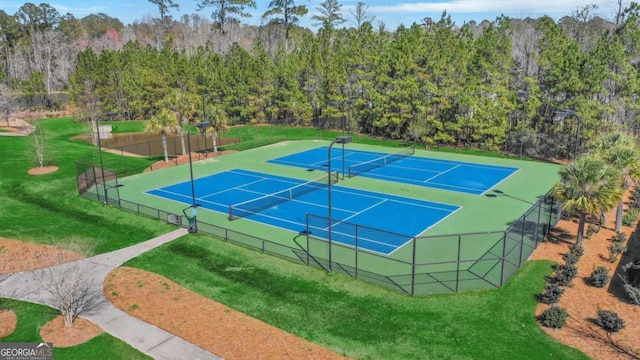 view of tennis court with a lawn