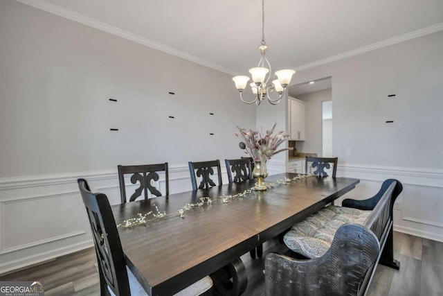 dining area featuring a chandelier, crown molding, and dark hardwood / wood-style floors