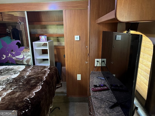 bedroom featuring wooden walls