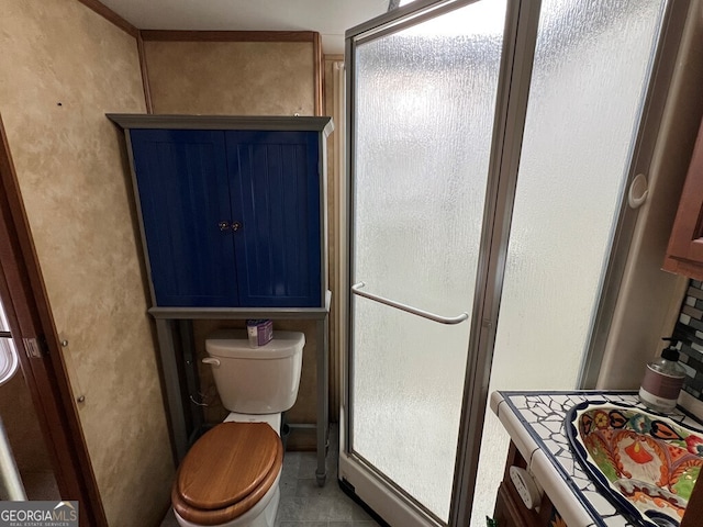 bathroom featuring toilet, tile patterned floors, and walk in shower