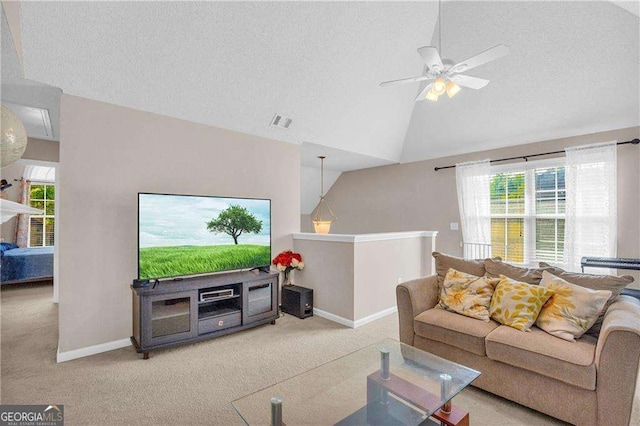 carpeted living room with ceiling fan, vaulted ceiling, and a textured ceiling