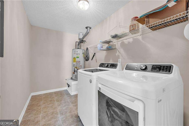 laundry area featuring a textured ceiling, light tile patterned flooring, washing machine and clothes dryer, and gas water heater