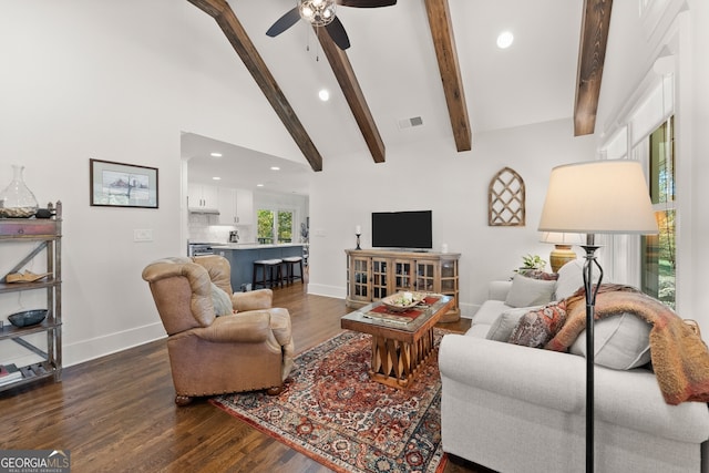 living room with ceiling fan, dark hardwood / wood-style flooring, beam ceiling, and high vaulted ceiling