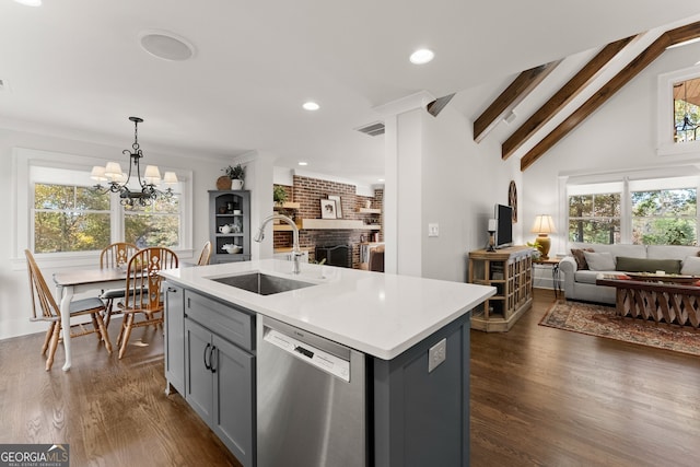 kitchen featuring a notable chandelier, stainless steel dishwasher, vaulted ceiling with beams, sink, and an island with sink