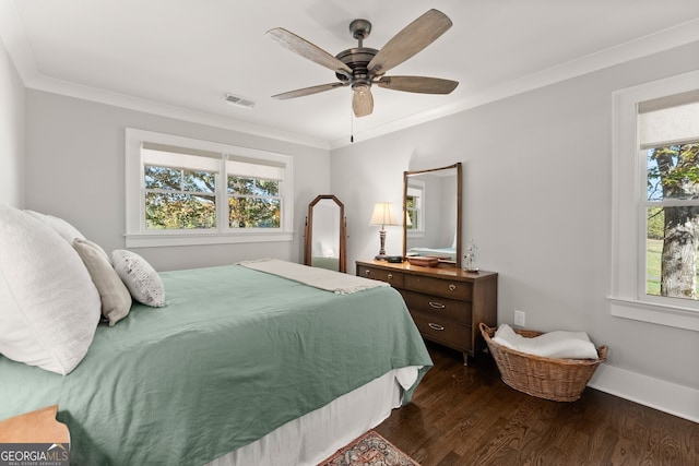 bedroom featuring ceiling fan, dark hardwood / wood-style floors, and crown molding