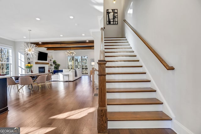 stairway featuring ornamental molding and hardwood / wood-style floors