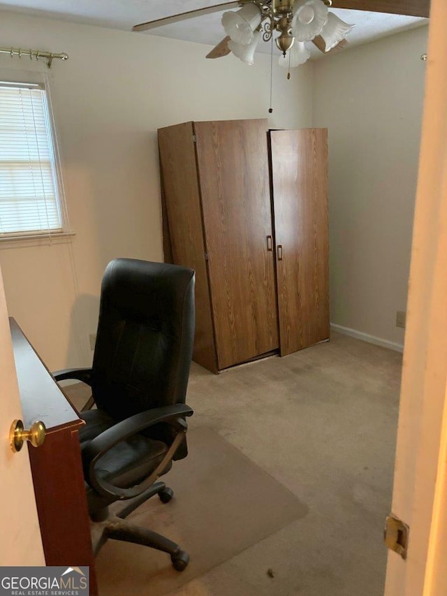 carpeted office with ceiling fan