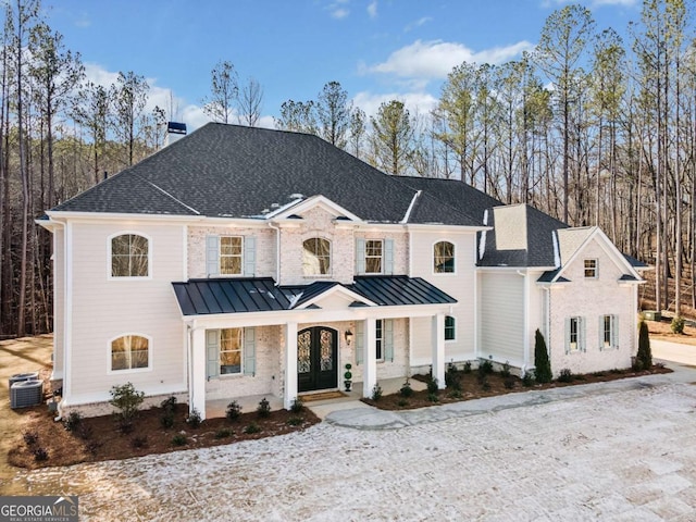 modern farmhouse style home featuring central AC unit and a porch