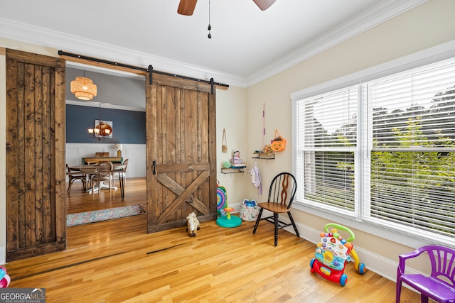 189 Bear Cub Way, Bogart, GA 30622 - rec room with a barn door, wood finished floors, ornamental molding, and a ceiling fan