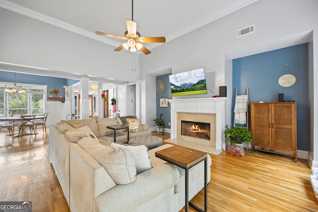189 Bear Cub Way, Bogart, GA 30622 - living room featuring wood finished floors, ornamental molding, a fireplace, a chandelier, and a ceiling fan