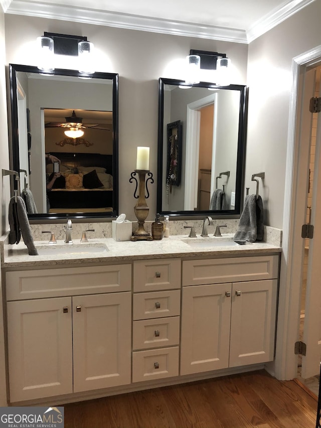 bathroom featuring vanity, hardwood / wood-style floors, crown molding, and ceiling fan