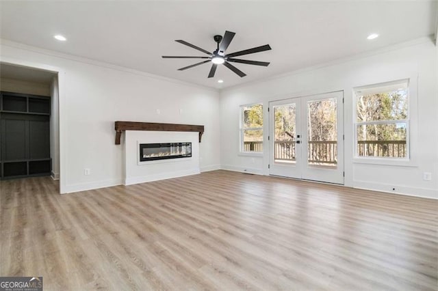 unfurnished living room featuring ceiling fan, light hardwood / wood-style flooring, ornamental molding, and french doors