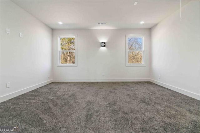 empty room featuring dark colored carpet