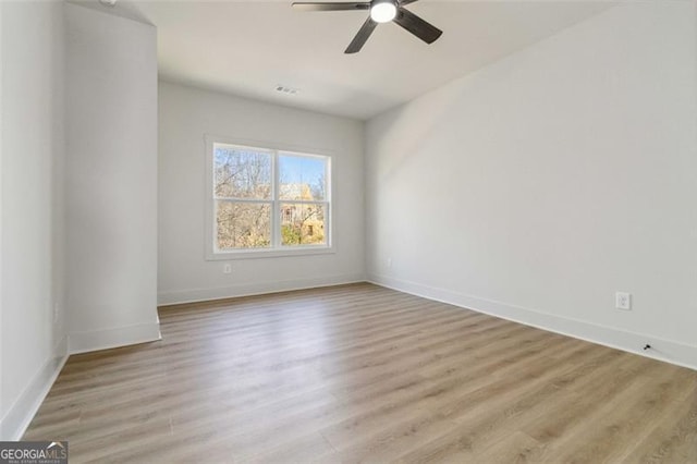 spare room with ceiling fan and light hardwood / wood-style floors