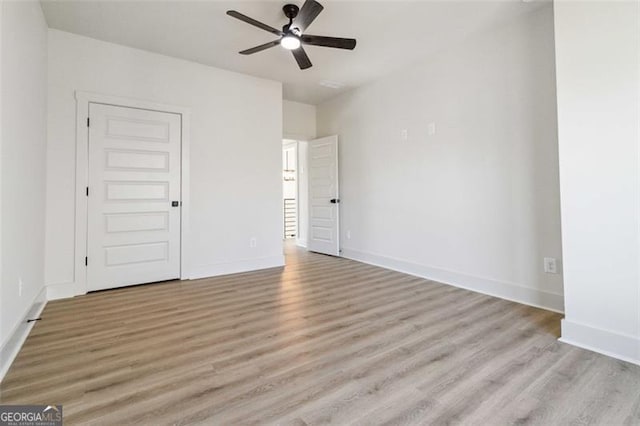 unfurnished room featuring ceiling fan and light hardwood / wood-style flooring