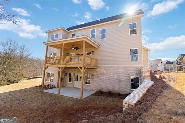 rear view of property with ceiling fan and a patio