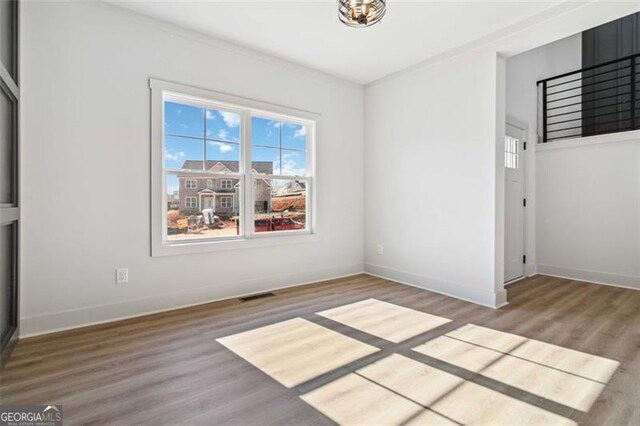 unfurnished room with wood-type flooring