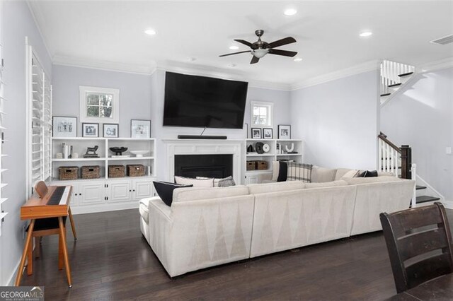 living room featuring ceiling fan, sink, dark hardwood / wood-style flooring, and ornamental molding